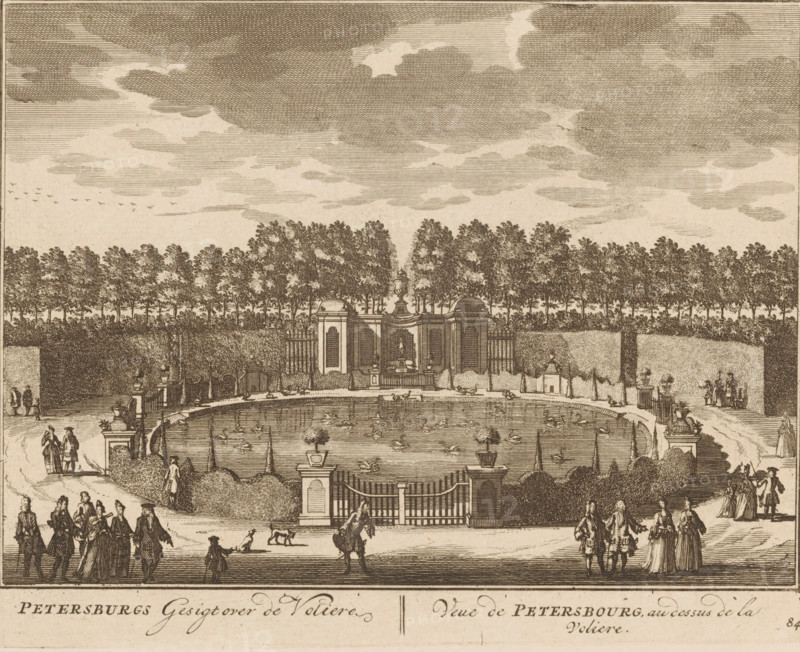 Petersburg View over the Aviary, View of Petersbourg, above the aviary, View of the aviary of the Petersburg house, print, book illustration, Series number, 84, 98, printmaker: Daniël Stopendaal (possibly), publisher: widow Nicolaes Visscher (II), Amsterdam, 1719, paper, etching, height 160 mm x width 205 mm, A sepia-toned engraving shows a formal garden scene with a large oval pond at center populated by many small birds on the water and decorative urns on pedestals along its edge; a gated entrance with stone pillars sits in front of the pond, flanked by clipped hedges and topiary. Behind the pond a low ornate pavilion with arched openings and a central urn is set against a dense avenue of tall trees forming a backdrop, with additional hedges and architectural elements along the sides. Groups of people in period dress walk and converse along paths in the foreground and near the pond, and a few small animals appear near the figures; the sky above is filled with layered clouds and a sma...