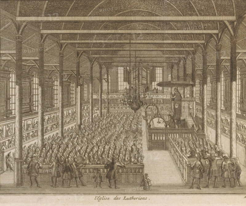 The Lutheran church in Leiden seen from the inside, L'eglise des Lutheriens, print, book illustration, The Lutheran church in Leiden seen from the inside. Numbered bottom right: 21., publisher: Pieter van der Aa (I) (possibly), Leiden, 1712, Pieter van der Aa (I), printmaker, publisher, paper, engraving, etching, height 139 mm x width 169 mm, Print also used in: Les delices de Leide, une des célébres villes de l'Europe, according to the exact description of the son's antiquity, his diverse aggrandissemens, his academy, his manufactures, his curiosities, Leiden: Pieter van der Aa, 1712., interior of church, Protestant Churches and denominations (LUTHERANS), Lutherse kerk (Leiden), A detailed monochrome engraving of a large interior space with tall columns supporting a vaulted ceiling and horizontal beams, rows of arched windows along the side walls, multiple tiers of wooden balconies with railings, and a central aisle flanked by densely packed seated figures. A large ornate chandelier h...
