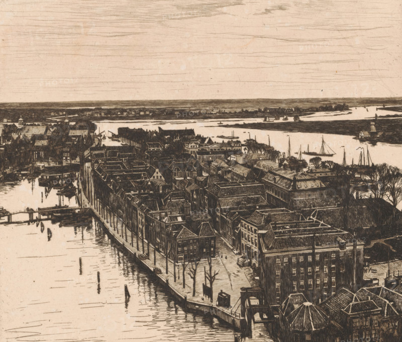 View of Dordrecht looking north from the tower of the Grote Kerk, Dordrecht I (original title), Harbour, Dordrecht (original title), print, annotation: '15a, 4, 77 in drawn triangle', annotation: '2nd state', printmaker: Willem Witsen (signed by artist), 1900, paper, etching, intaglio printmaking technique, height 323 mm x width 368 mm, city-view in general, 'veduta', river, A detailed sepia-toned etching shows a riverside town seen from above with rows of tightly packed buildings and rooftops lining a waterfront street, bare trees dotting the sidewalk, and small docks extending into calm water; boats and sailboats are moored or sailing on the river, a bridge spans the water near the foreground, and a wide expanse of sky with horizontal sketch lines stretches above the distant flat shoreline.