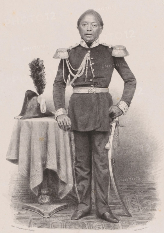 Portrait of Youda Negara, Prince of Djoejocarta, print, The sitter stands next to a table with a bicorne hat on it. He is wearing a military uniform., printmaker: Johan Hendrik Hoffmeister, printer (person): Royal Lithographic Printing House of E. Spanier, The Hague, c. 1851 - c. 1883, 1860, printer (person), paper, chine collé, lithography, lithography on chine collé, height 555 mm x width 440 mm, historical persons (full length portrait), Java, Central Java, Yogyakarta, A full-length portrait of a person standing and facing forward, wearing a dark formal military uniform with decorative braided cords across the chest, ornamental shoulder epaulettes, a high collar, patterned cuffs, and a belt with a central decorative buckle; one hand rests on the edge of a small round table draped with a cloth, the other hand holds the hilt of a curved sword hanging at the side; a tall plumed hat sits on the table beside the person; the figure wears fitted trousers and pointed shoes and stands on a p...