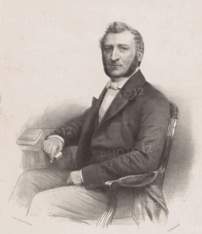 Portrait of an unknown man, possibly Robert Voûte, print, The sitter is seated at a table and has large sideburns., printmaker: Johan Hendrik Hoffmeister, Netherlands, printer (person): Koninklijke Steendrukkerij van E. Spanier, The Hague, 1851 - c. 1883, printer (person), paper, chine collé, lithography, lithography on chine collé, height 477 mm x width 330 mm, Person, Robert Voûte, historical persons ((full) bust portrait), sideburns, A charcoal or pencil portrait of a seated man shown from the waist up wearing a dark suit jacket, a light shirt, and a bow at the collar, with sideburns and neatly combed hair, one arm resting on the arm of a carved wooden chair and the other arm resting on a table where a closed book sits, the shading and line work creating soft textures on the clothing and chair against a plain light background.