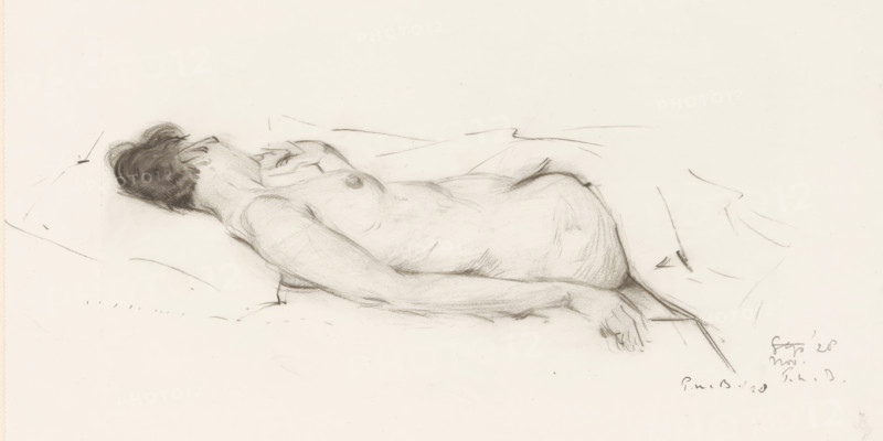 Reclining nude, drawing, draftsman (artist): Pieter Willem van Baarsel, 1928-11, draftsman (artist), inorganic material, paper, chalk, black chalk, height 251 mm x width 353 mm, lying figure - AA - female human figure (nude human being), A pencil sketch of a reclining nude figure shown from the side, lying on a surface with head resting on a pillow and hair shaded dark, the torso and upper thigh rendered with soft shading and contour lines, one arm extended alongside the body with the hand resting near the hip, subtle line marks indicating folds of the surface and surrounding area, and small, loose gesture marks around the figure.