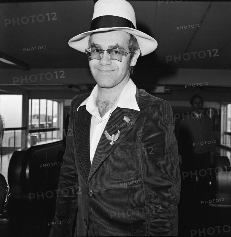 Elton John leaves Heathrow Airport. He is going to Los Angeles for the party of Elton John's Manager.

Picture taken 9th September 1974