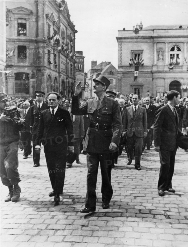 General De Gaulle waves to the wildly cheering crowds
of his countrymen as he leaves the town square of
Laval, France, following an address to the citizens
of the recently liberated town.
24th August 1944.