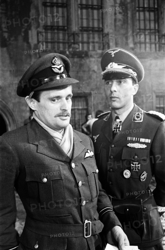 Actors David McCallum (left) and Anthony Valentine on the film set during filming of 'Colditz', the BBC TV series. David McCallum played the part of Flight Lieutenant Simon Carter and Anthony Valentine played Major Horst Mohn, 2nd in command. Ealing Studios, London, 7th September 1973.