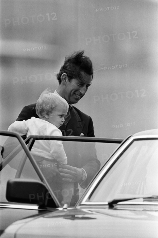 The Royal Family arrive for their summer holiday at Balmoral, Scotland. Prince Charles, Prince of Wales carries Prince William at Aberdeen Airport. 15th August 1983.