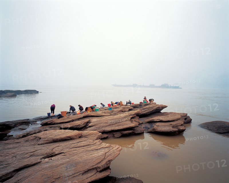 People wash cloth on the rocks, China