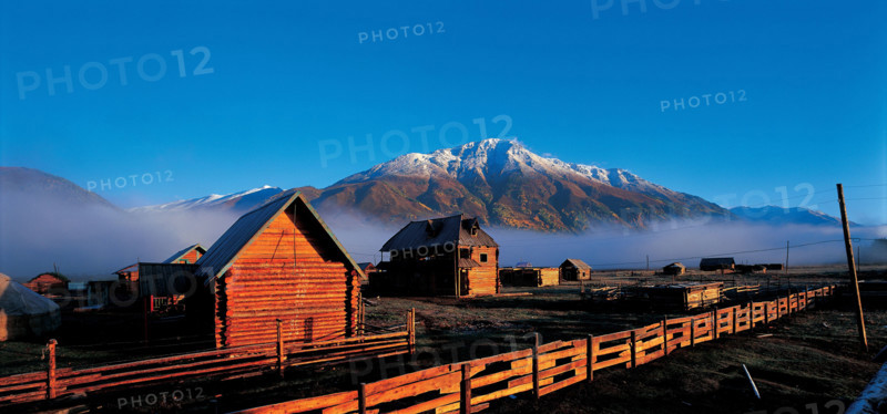 The scenery of frame houses and snow-covered mountains in Sinkiang,China
