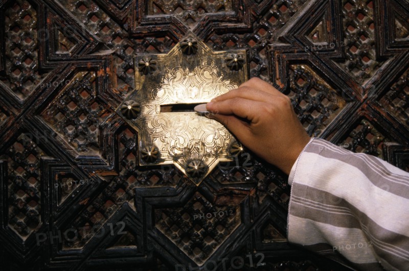 Giving Zakat, Alms, Kairouine Mosque in Fez, Morocco