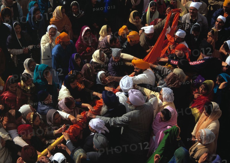 Changing the cover on the flagpole at Baisakhi, New Year