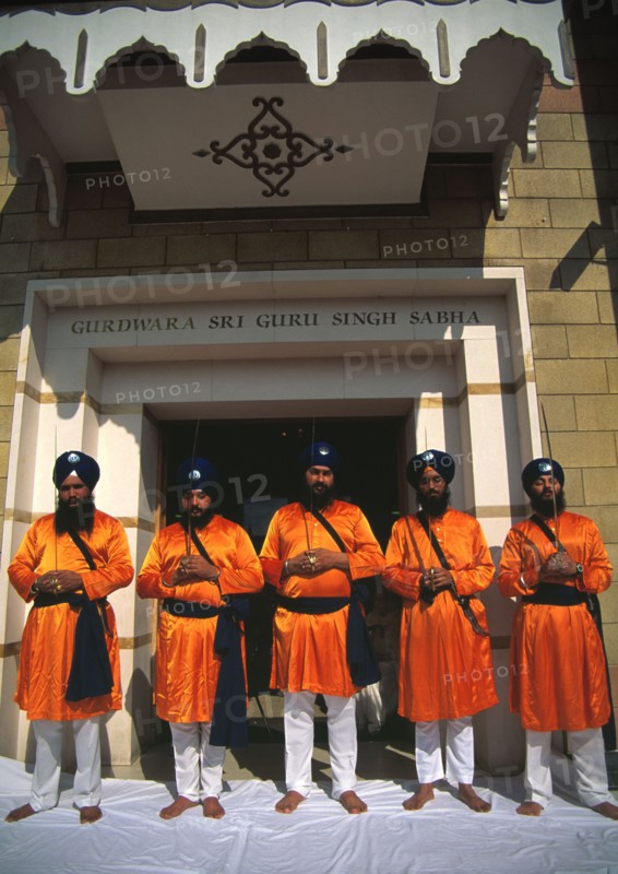 Five men who represent the Panj Piarey outside the gurdwara