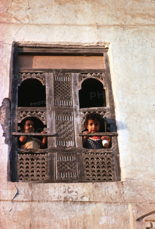 Children at a window in Salalah, Sultanate of Oman
