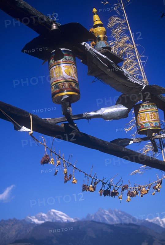 Buddhist prayer wheels turning in the wind on a temple
in Nepal