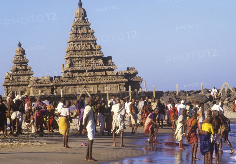 Shore temple at Mamalapuram, Tamil Nadu, with pilgrims bathing in the sea