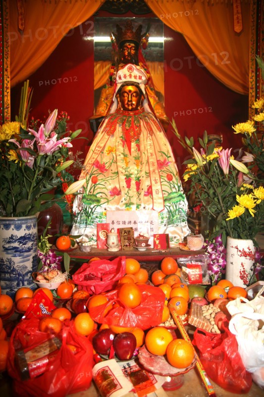 Chinese Goddess of Merchy Kuan Yin with new year offerings Hongkong