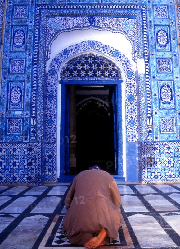 Man prays in front of the qiblah or prayer niche