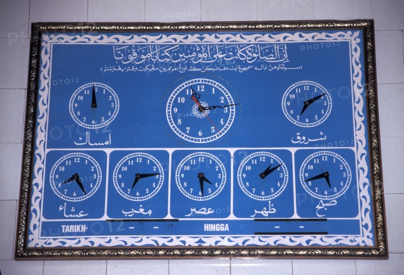 Prayers time on a board outside a mosque in Morocco