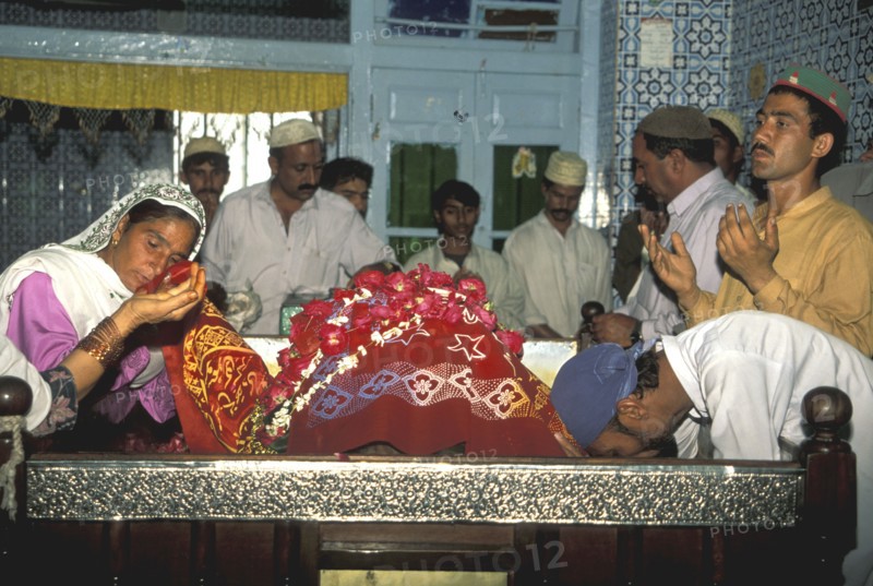 Pilgrims kissing the shroud of Abd.Shah Ghazi Muslim saint in Karachi