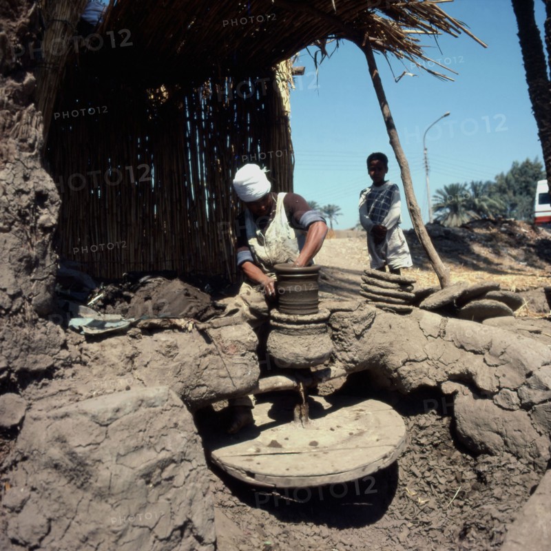 Potter making a vase on his wheel