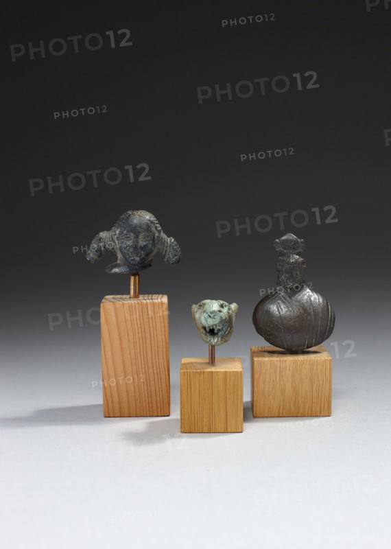 Roman heads from a statuette and weight