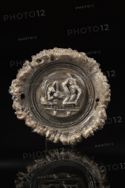 Roman phalera carved with an erotic scene