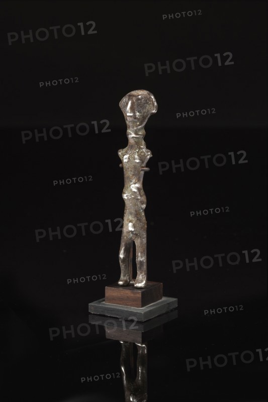 Statuette votive représentant un personnage stylisé, la tête au nez en bec d'aigle