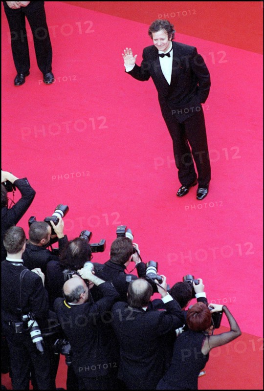 05/09/2001. 54th Cannes Film Festival: Francis Huster walking up the stairs.
