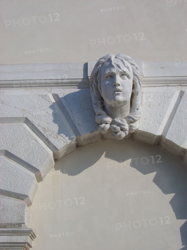 Sculpted head on a facade in the district of Dorsoduro in Venice