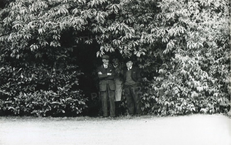 Men sheltering from rain, Herbert Park, Dublin