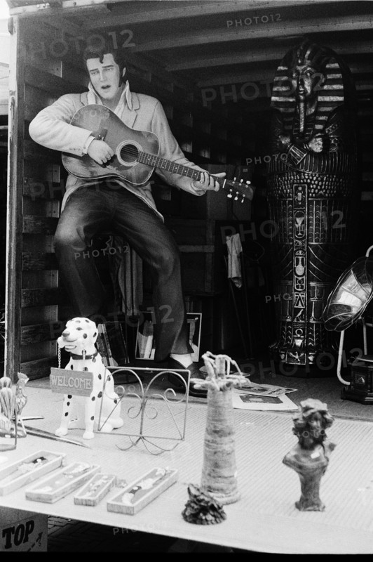 Flea market: a large figurine of Elvis playing the guitar and various other items for sale. Amsterdam, Netherlands.
2000
