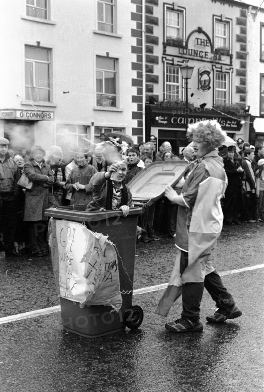 St Patrick’s Day parade: a child emerges from a wheelie bin (in the style of Oscar the Grouch) that has been turned into a makeshift float. Swinford, County Mayo, Ireland.
2001