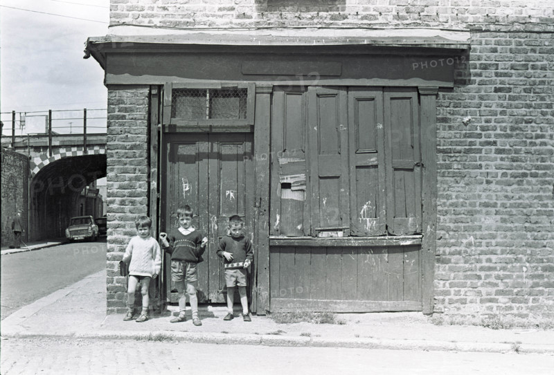 Children outside a closed shop, Dublin, Ireland