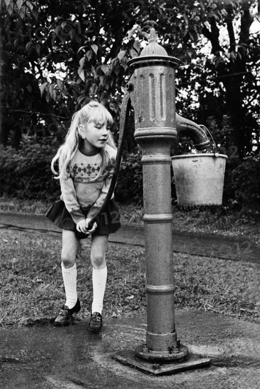 Girl at water pump, County Meath