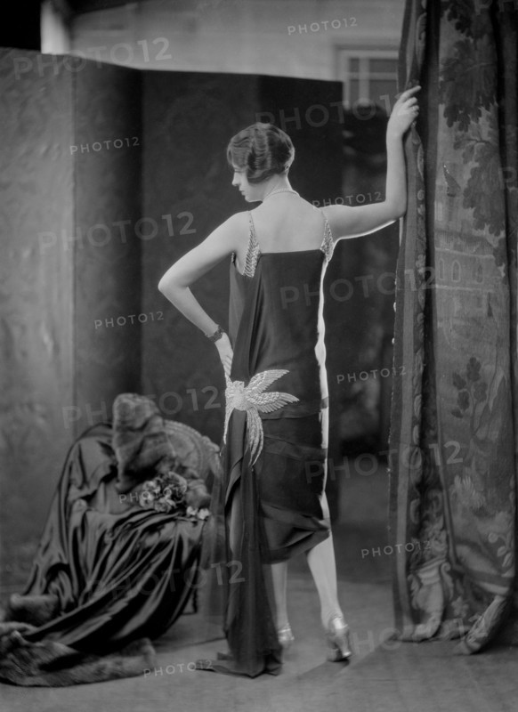 Female model wearing a dress designed by Worth
