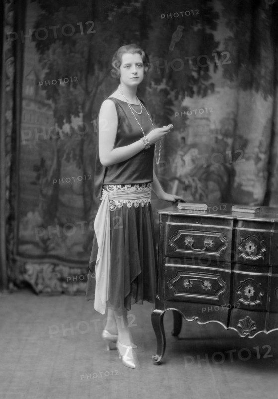 Female model wearing a dress designed by Worth