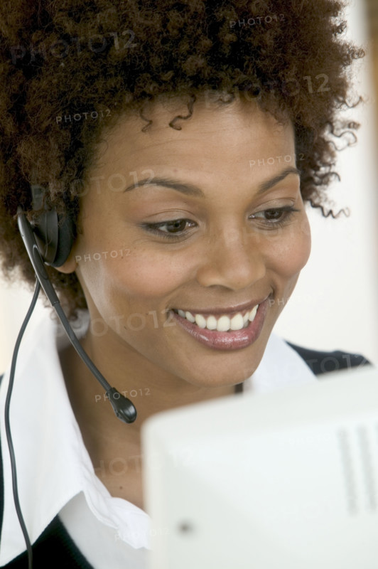 Woman wearing telephone headset.