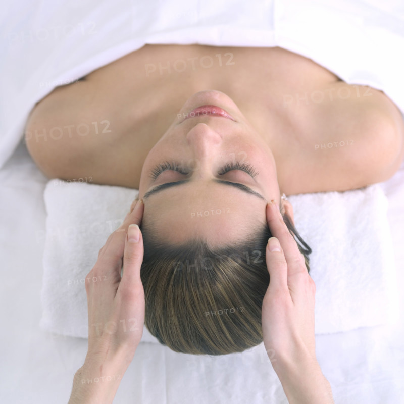 Woman receiving a head massage.