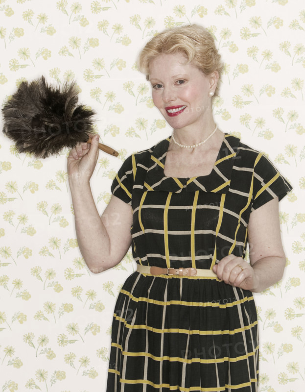 Woman holding a feather duster.