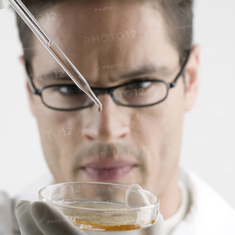 Lab technician with Petri dish.