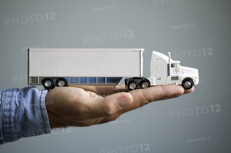 Close up of man's hand holding toy truck.