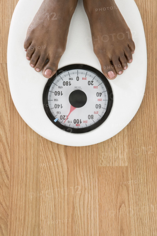 Feet on a scale as seen from overhead.