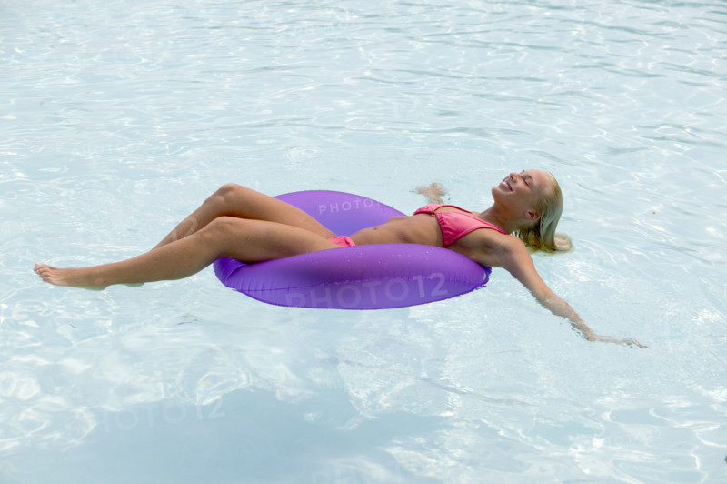 Woman floating in a swimming pool.