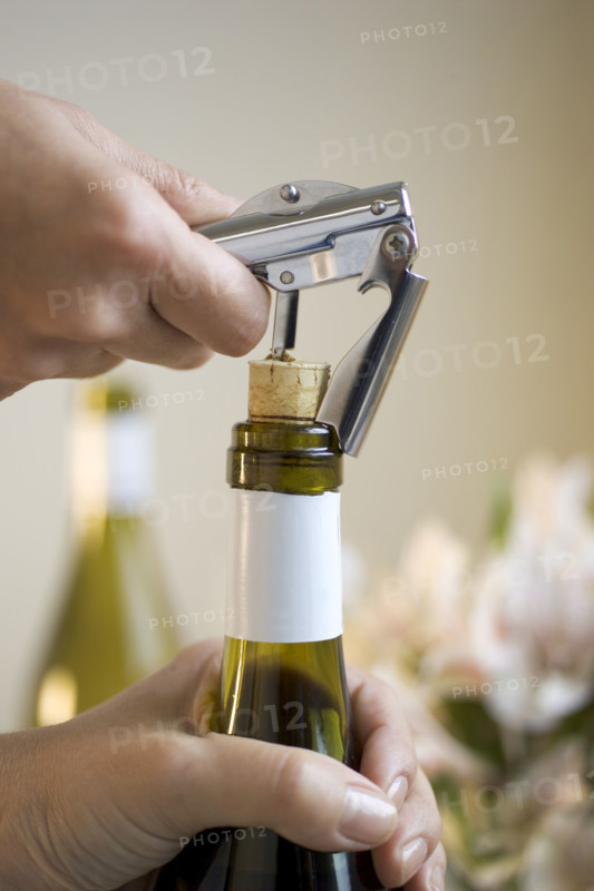 Opening a bottle of wine.