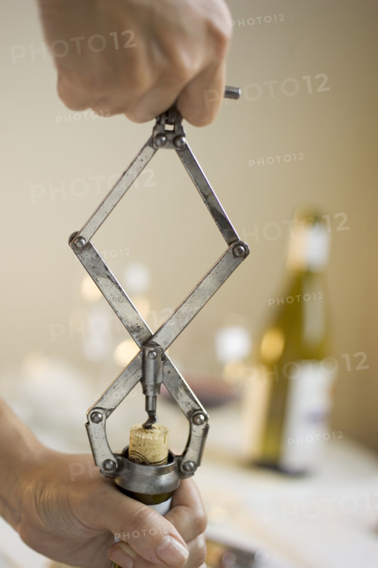 Opening a bottle of wine.