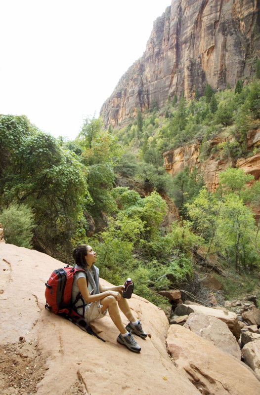 Female hiker resting on a rock.