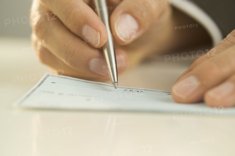 Man writing out a check.