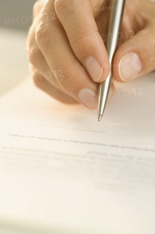 Man signing a document.