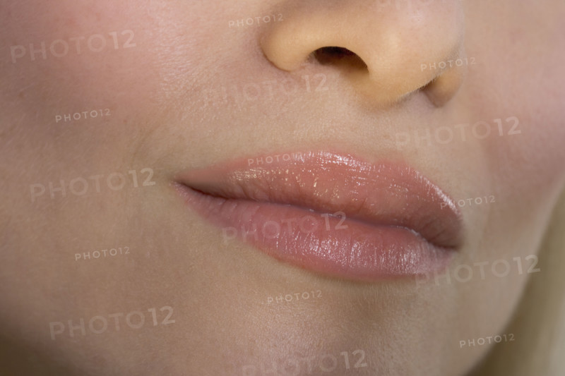 Closeup of woman's lips and nose.