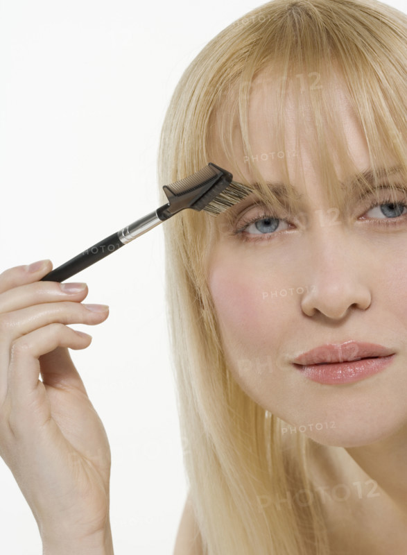 Woman using cosmetic brush.