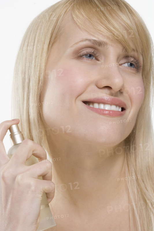 Smiling woman with spray bottle.